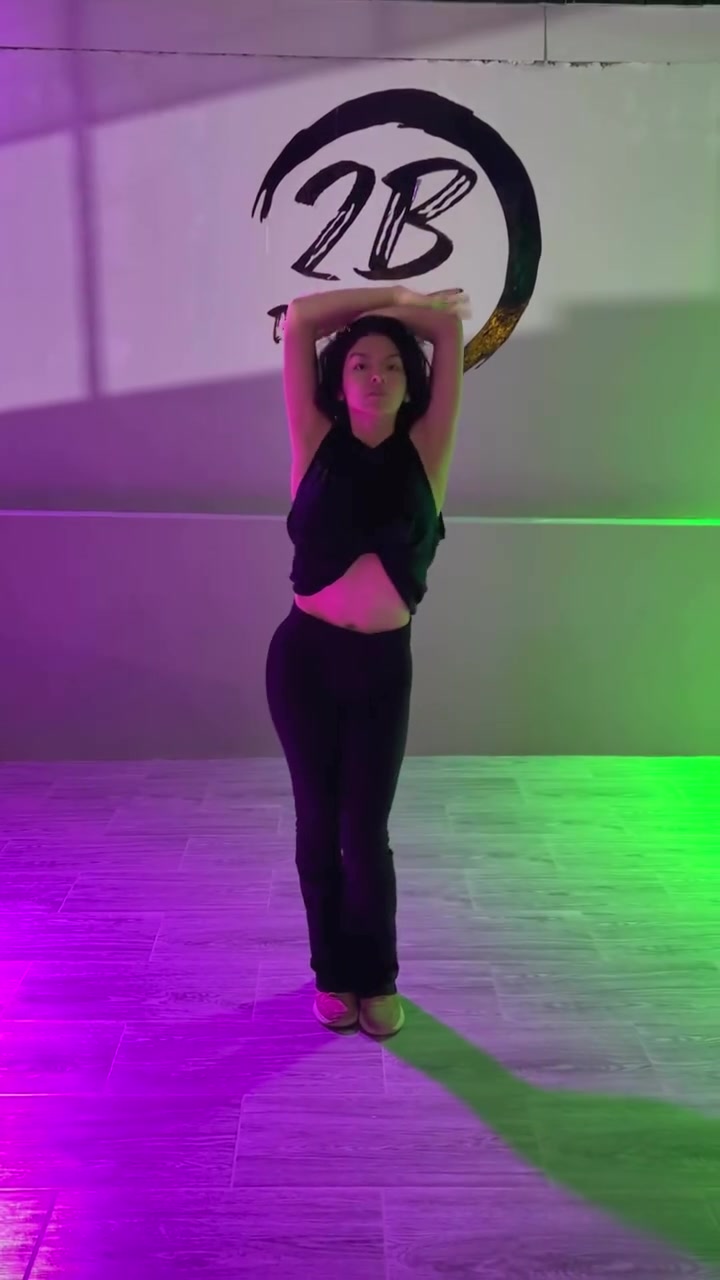 Yamelin dancing in front of the 2B Dance Studio logo